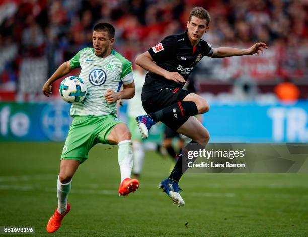 Ignacio Camacho of Wolfsburg is challenged by Lars Bender of Leverkusen during the Bundesliga match between Bayer 04 Leverkusen and VfL Wolfsburg at...