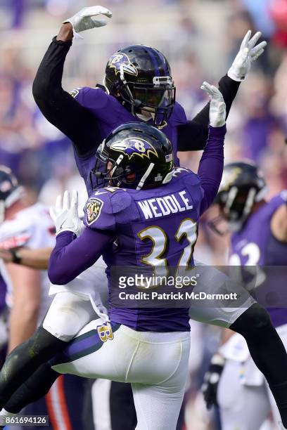 Free Safety Eric Weddle of the Baltimore Ravens celebrates with a teammate after a turnover against the Chicago Bears at M&T Bank Stadium on October...