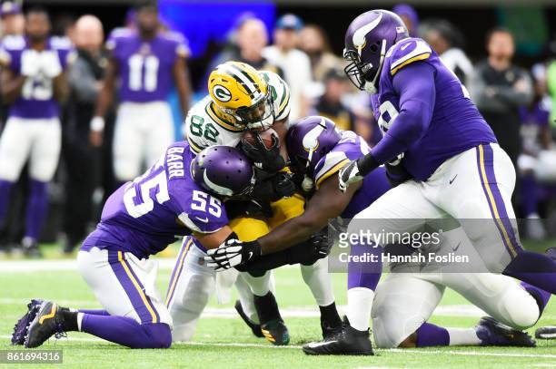 Ty Montgomery of the Green Bay Packers is tackled by Anthony Barr and Shamar Stephen of the Minnesota Vikings during the second quarter of the game...