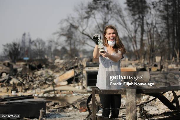 Margaret Curzon shows her mother Karen a ceramic figurine salvaged from her childhood home in the Coffey Park neighborhood on October 15, 2017 in...