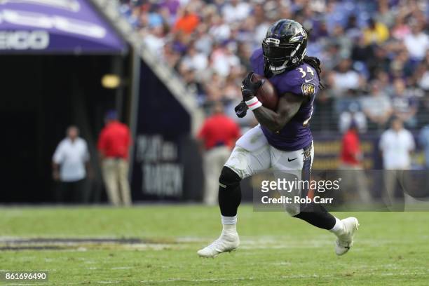 Running Back Alex Collins of the Baltimore Ravens carries the ball in the third quarter against the Chicago Bears at M&T Bank Stadium on October 15,...