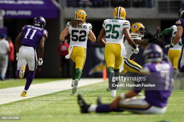 Clay Matthews of the Green Bay Packers carries the ball past the Minnesota Vikings offense after a fumble recover during the second quarter of the...