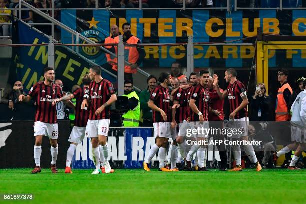 Milan's midfielder Suso from Spain celebrates with teammates after scoring during the Italian Serie A football match Inter Milan Vs AC Milan on...