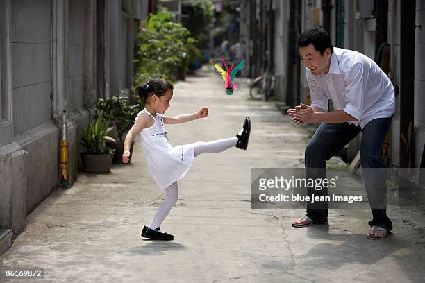 a father and daughter play a traditional game - birdie stock pictures, royalty-free photos & images