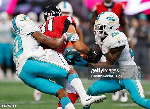 Cordrea Tankersley defends as Reshad Jones of the Miami Dolphins intercepts this pass intended for Austin Hooper of the Atlanta Falcons at...