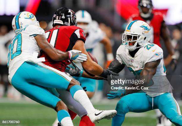 Cordrea Tankersley defends as Reshad Jones of the Miami Dolphins intercepts this pass intended for Austin Hooper of the Atlanta Falcons at...