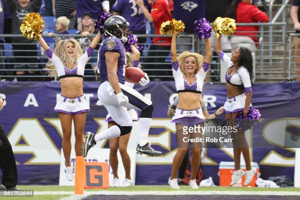 Wide Receiver Michael Campanaro of the Baltimore Ravens celebrates after returning a punt for a touchdown in the fourth quarter against the Chicago...
