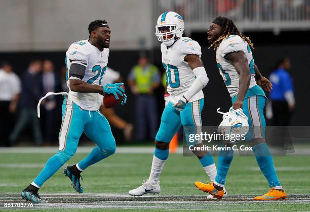 Reshad Jones of the Miami Dolphins reacts after intercepting a pass intended for Austin Hooper of the Atlanta Falcons in the final seconds with...