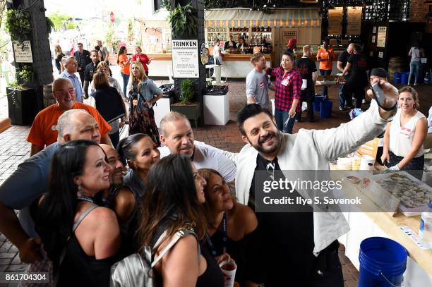 Host Adam Richman takes a selfie with guests during Oyster Bash presented by Barnegat Oyster Collective sponsored by Modelo hosted by Adam Richman at...