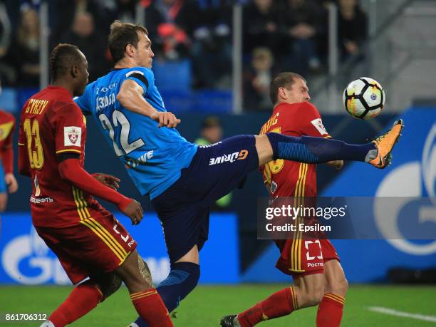 Artem Dzuyba of FC Zenit St. Petersburg vies for the ball with Stophira Sunzu and Alexandru Bourceanu of FC Arsenal Tula during the during the...