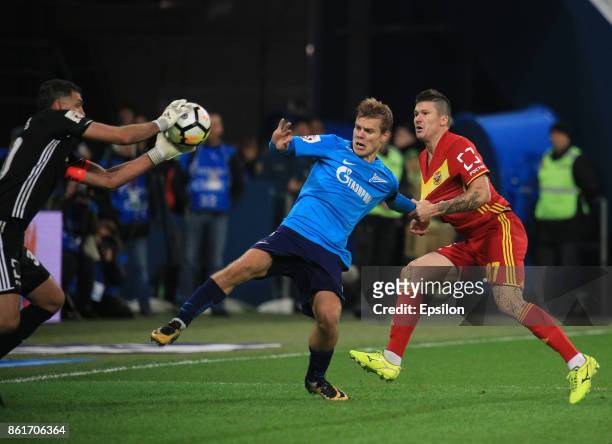 Alexander Kokorin of FC Zenit St. Petersburg vies for the ball with Ilya Maximov and Vladimir Gabulov of FC Arsenal Tula during the during the...