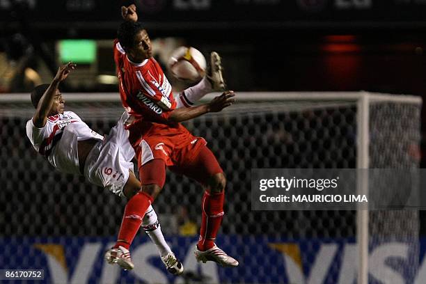 Wilmer Parra , of Colombia's America de Cali, vies for the ball with Junior Cesar, of Brazil's Sao Paulo FC, during their 2009 Libertadores Cup...