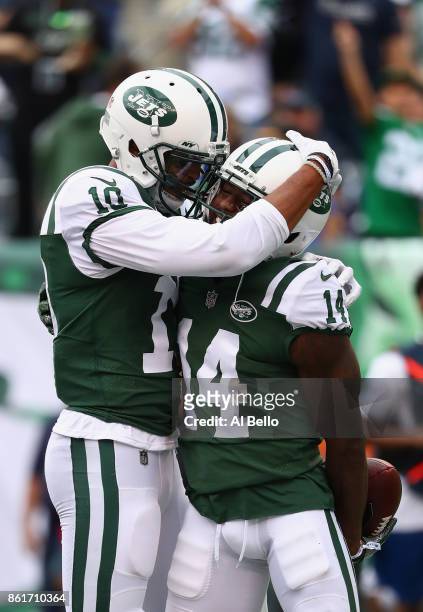 Wide receiver Jeremy Kerley of the New York Jets celebrates his 31-yard touchdown with teammate wide receiver Jermaine Kearse against the New England...
