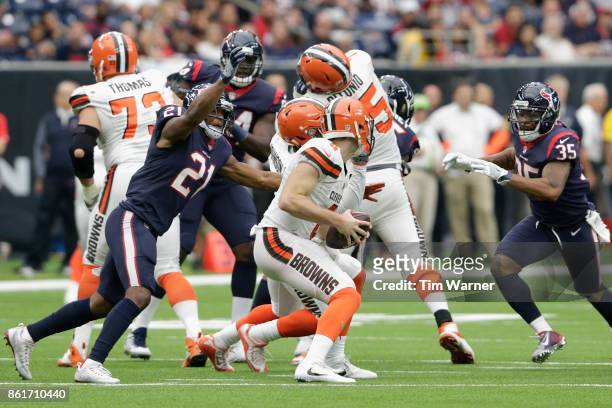Quarterback Kevin Hogan of the Cleveland Browns is pressured by Marcus Gilchrist and Eddie Pleasant of the Houston Texans in the third quarter at NRG...