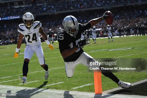 Michael Crabtree of the Oakland Raiders scores a touchdown against the Los Angeles Chargers during their NFL game at Oakland-Alameda County Coliseum...