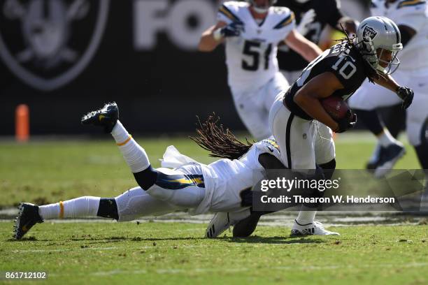 Seth Roberts of the Oakland Raiders is tackled after a catch against the Los Angeles Chargers during their NFL game at Oakland-Alameda County...