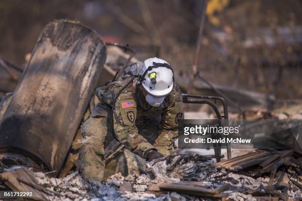 California National Guard troops search burned homes near Mark West Springs Road and Old Redwood Highway on October 15, 2017 in Santa Rosa,...