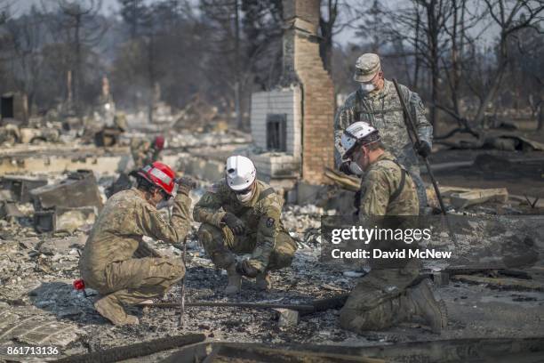 California National Guardsmen find bones at a fire-devastated home near Mark West Springs Road and Old Redwood Highway on October 15, 2017 in Santa...