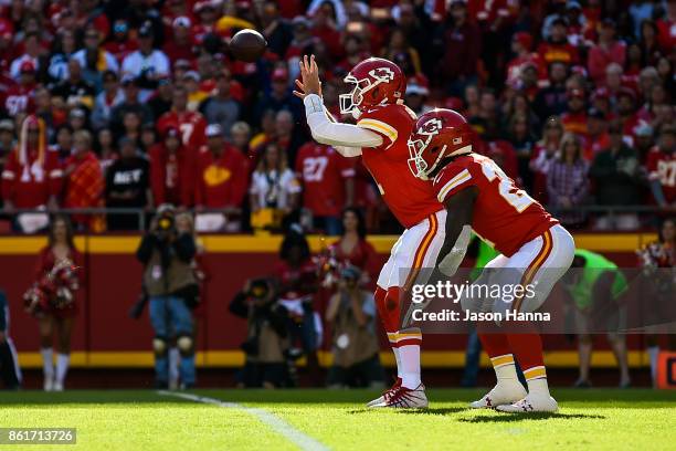 Quarterback Alex Smith of the Kansas City Chiefs has a high snap go over his head leading to a safety for the first score of the game against the...