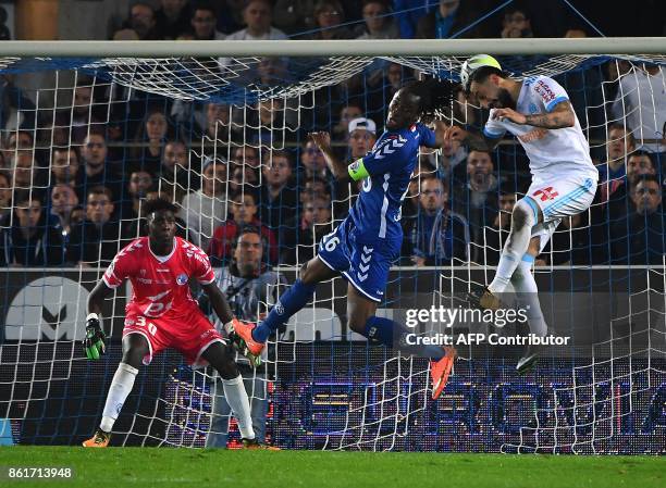 Olympique de Marseille's Greek forward Konstantinos Mitroglou vies with Strasbourg's Burkinabe defender Bakary Kone as Strasbourg's French goalkeeper...