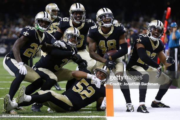 The New Orleans Saints defense celebrates during the second half of a game against the Detroit Lions at the Mercedes-Benz Superdome on October 15,...