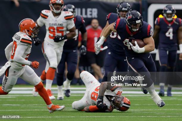 Jay Prosch of the Houston Texans runs after a catch by Christian Kirksey and Briean Boddy-Calhoun of the Cleveland Browns at NRG Stadium on October...