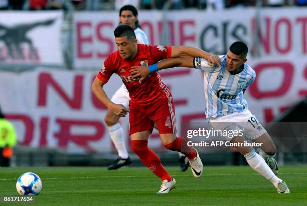 River Plate's defender Jorge Moreira vies for the ball with Atletico Tucuman's midfielder David Barbona during their Argentina First Division...