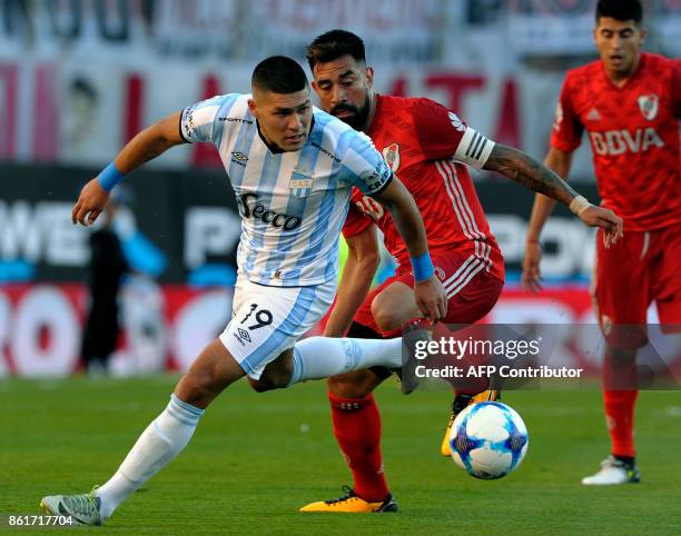 Atletico Tucuman's midfielder David Barbona vies for the ball with River Plate's midfielder Ariel Rojas during their Argentina First Division...