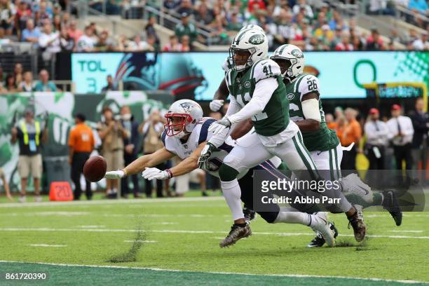 Wide receiver Chris Hogan of the New England Patriots tries for an incomplete pass against cornerback Buster Skrine of the New York Jets during the...