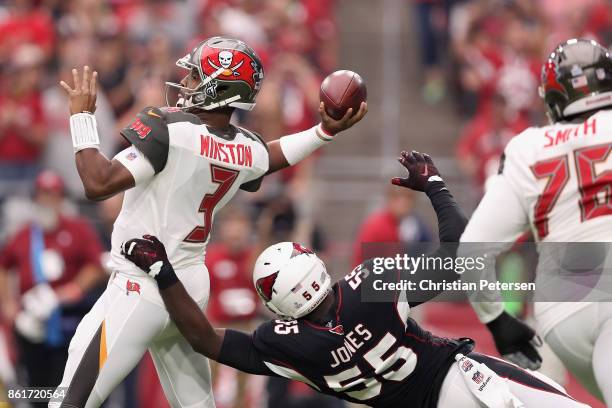 Quarterback Jameis Winston of the Tampa Bay Buccaneers throws a pass under pressure from outside linebacker Chandler Jones of the Arizona Cardinals...