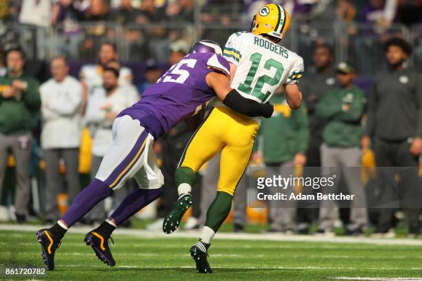 Anthony Barr of the Minnesota Vikings hits quarterback Aaron Rodgers of the Green Bay Packers during the first quarter of the game on October 15,...