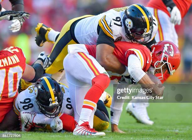 Kansas City Chiefs quarterback Alex Smith is sacked by Pittsburgh Steelers inside linebacker Vince Williams and defensive end Cameron Heyward in the...