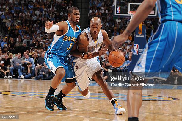 Chauncey Billups of the Denver Nuggets goes to the basket against Chris Paul of the New Orleans Hornets during Game Two of the Western Conference...