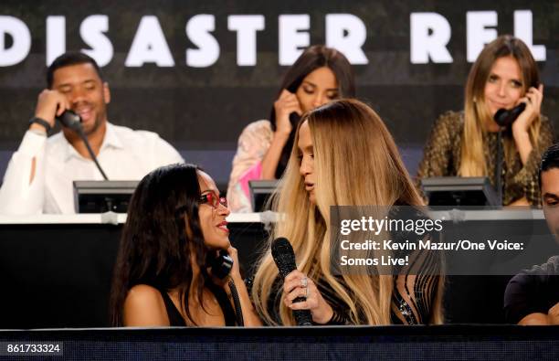 In this handout photo provided by One Voice: Somos Live!, actor Zoe Saldana and singer Jennifer Lopez speak onstage during "One Voice: Somos Live! A...