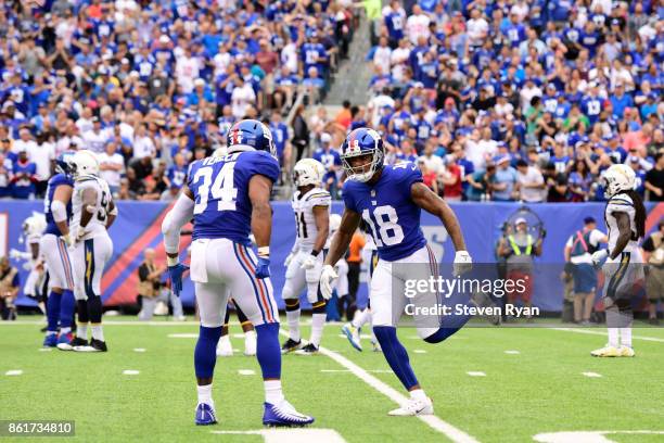 Shane Vereen and Roger Lewis of the New York Giants celebrate the play against the Los Angeles Chargers during an NFL game at MetLife Stadium on...