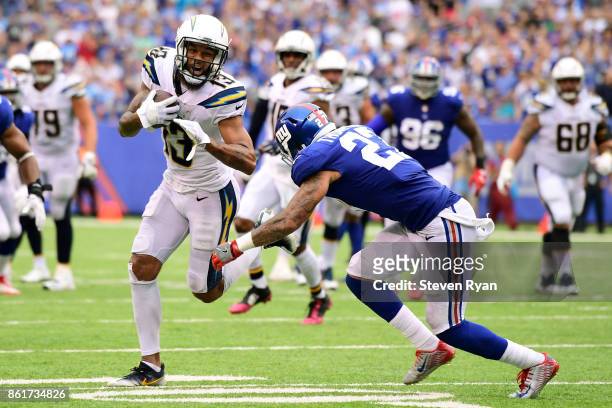Keenan Allen of the Los Angeles Chargers attempts to break the tackle of Darian Thompson of the New York Giants during an NFL game at MetLife Stadium...