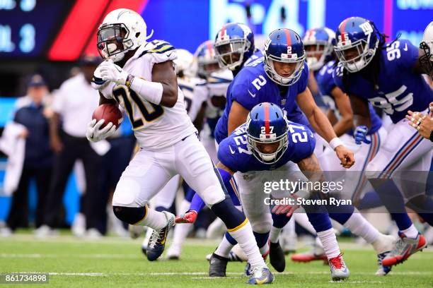 Desmond King of the Los Angeles Chargers attempts to break past Darian Thompson of the New York Giants on the kickoff during an NFL game at MetLife...