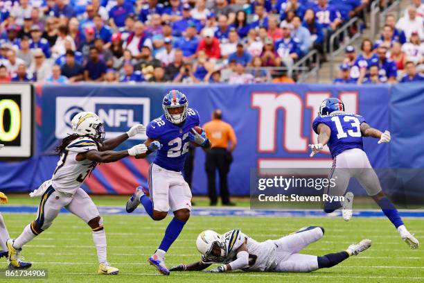 Odell Beckham blocks as Wayne Gallman of the New York Giants runs the ball past Jahleel Addae and Casey Hayward of the Los Angeles Chargers during an...