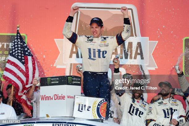 Brad Keselowski, driver of the Miller Lite Ford, celebrates in victory lane after winning the Monster Energy NASCAR Cup Series Alabama 500 at...