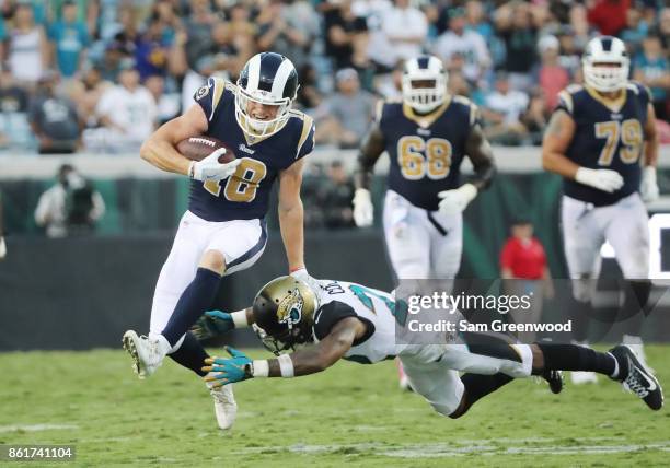 Cooper Kupp of the Los Angeles Rams runs with the football past Aaron Colvin of the Jacksonville Jaguars in the second half of their game at EverBank...