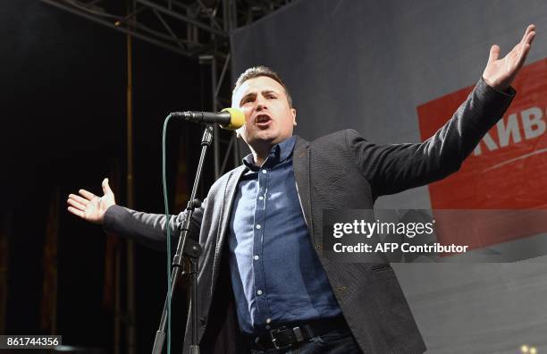 Zoran Zaev, leader of the rulling Social Democrat Union of Macedonia , greets supporters in front of the government building after local elections in...