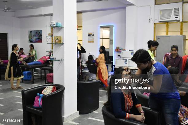 Students practice beauty treatments during a beauty and grooming class at an IACM Smart Learn Ltd. Learning center in New Delhi, India, on Tuesday,...