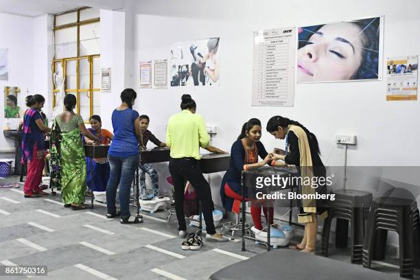 Students practice manicure treatments during a beauty and grooming class at an IACM Smart Learn Ltd. Learning center in New Delhi, India, on Tuesday,...