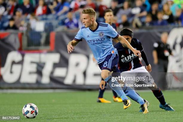 New York City FC midfielder Alexander Ring turns away from New England Revolution midfielder Lee Nguyen during a match between the New England...