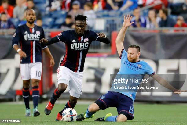 DNew York City FC midfielder Thomas McNamara slides in on New England Revolution midfielder Gershon Koffie uring a match between the New England...
