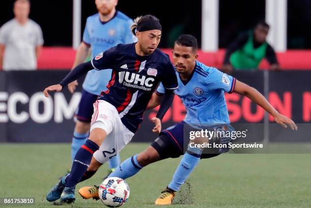 New England Revolution midfielder Lee Nguyen cuts away from New York City FC midfielder Yangel Herrera during a match between the New England...