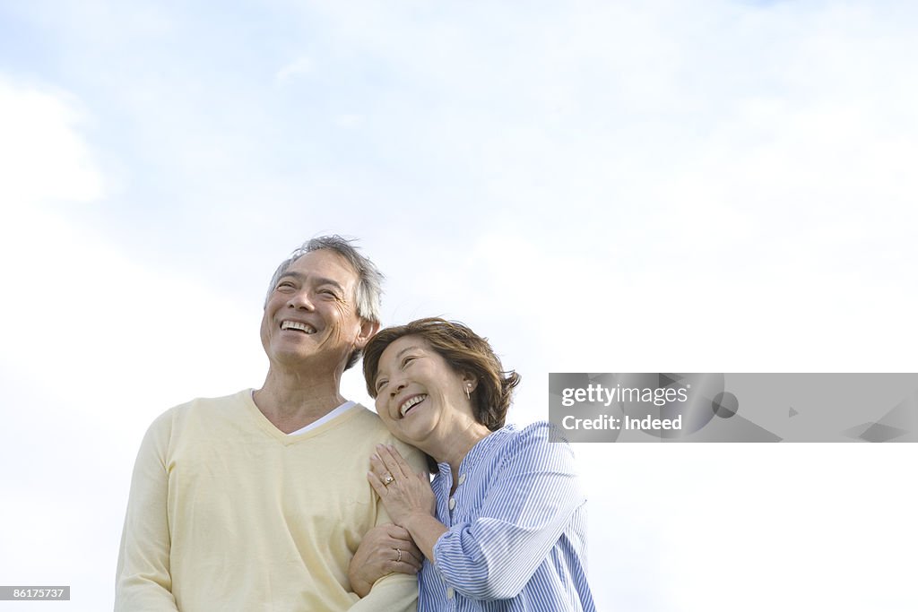 Mature woman embracing man, smiling