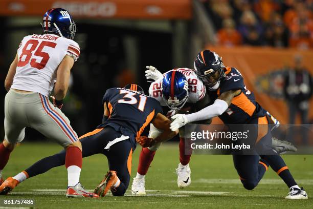 Justin Simmons and Brandon Marshall of the Denver Broncos combine to tackle Orleans Darkwa of the New York Giants in the first quarter. The Denver...