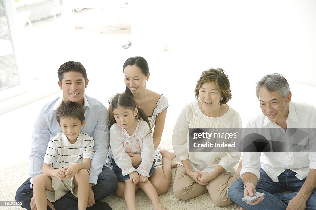Multigenerational family watching TV