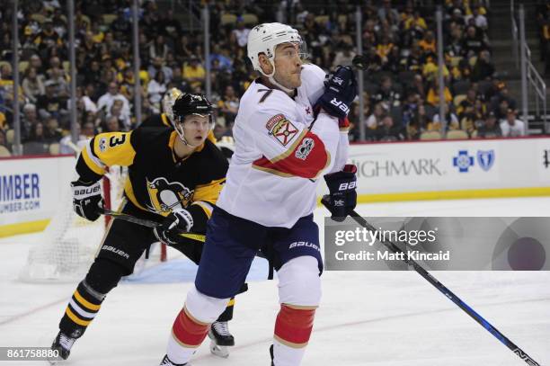Colton Sceviou of the Florida Panthers watches the puck against Olli Maatta of the Pittsburgh Penguins at PPG PAINTS Arena on October 14, 2017 in...